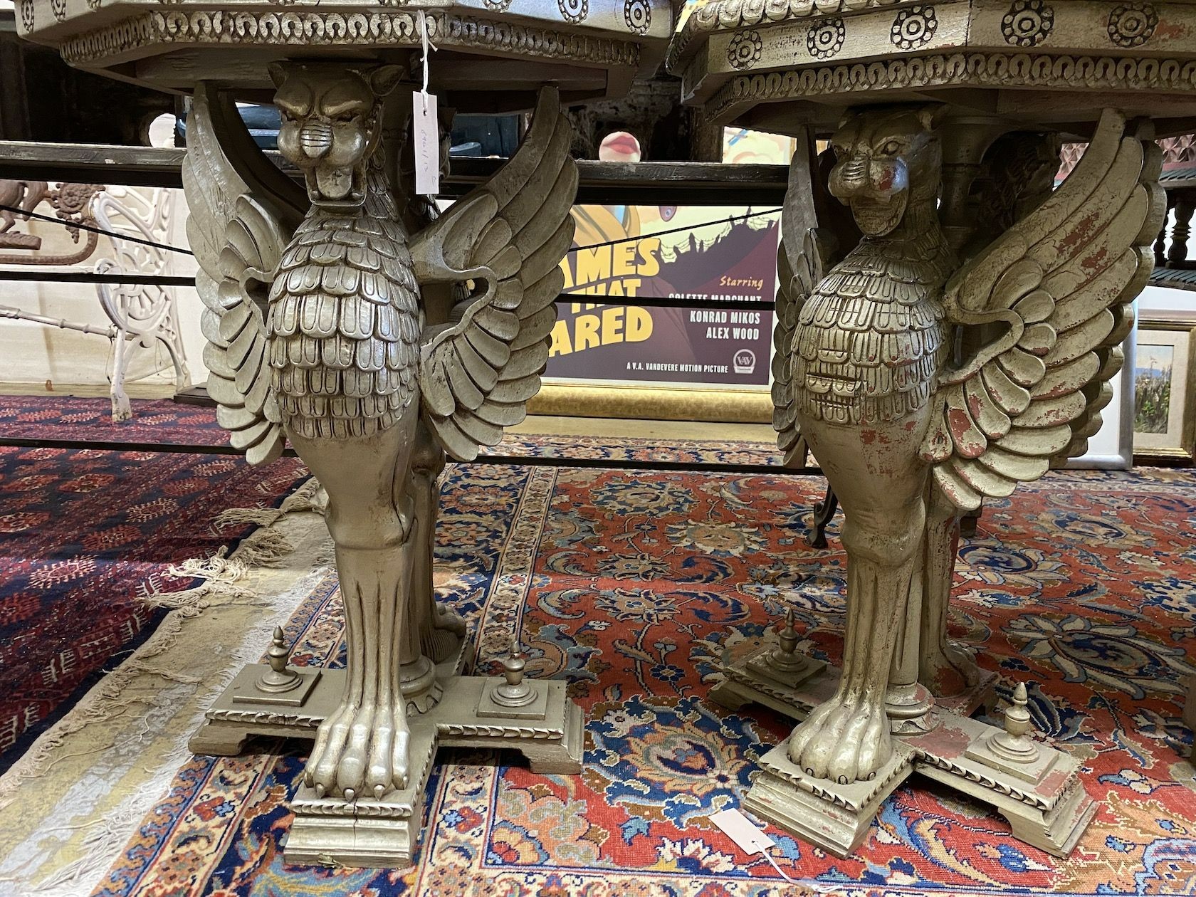 A pair of Empire style octagonal wooden centre tables with winged griffin supports, width 60cm, height 82cm